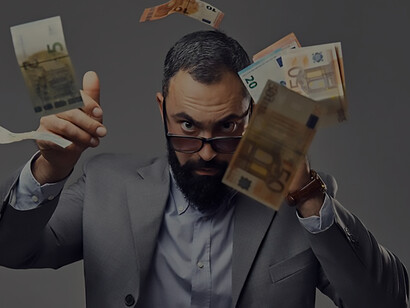 In a capitalist gesture, a suited bearded man skillfully snatches a floating money banknote