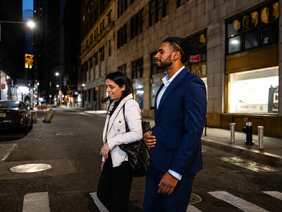 Business executives walking through a modern financial district at dusk