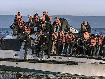 Syrian and Iraqi refugees arrive by boat at Skala Sykamias on the Greek island of Lesvos