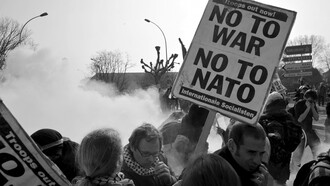 The photo from the NATO protest in Strasbourg, France in 2009, featuring a "No to War, No to NATO" banner