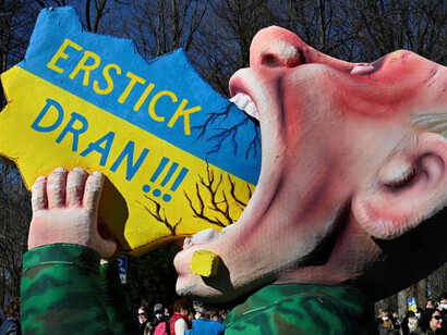 Putin swallowing Ukraine, with the words "Choke!!!" written on it, on March 13, 2022 in Berlin, Germany