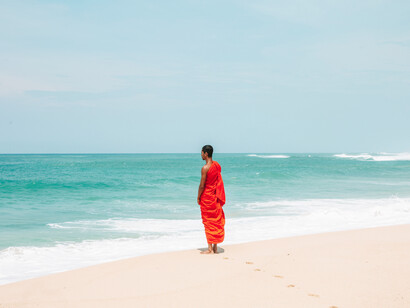 The sea and the energy it contains surrounds a monk who stands near