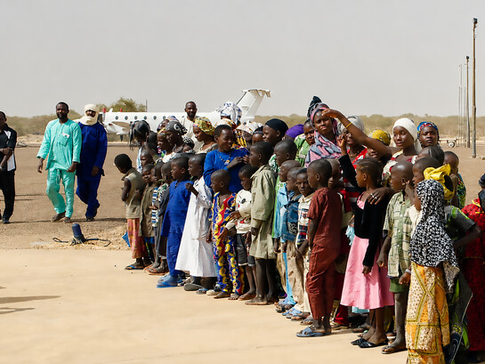 Crowds in Gao, Mali, form a guard of honour for humanitarian workers who arrived by plane in April to assess local needs