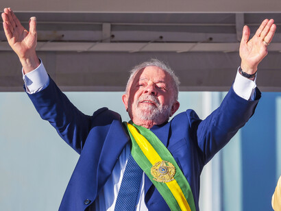 President da Silva waves to the enthusiastic crowd at The Palácio do Planalto in Brasília, Brazil, celebrating the ongoing success of Bolsa Família and its role in reducing hunger and improving social conditions in the country