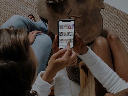 A couple checking out the myriad of paid social ads on their phone