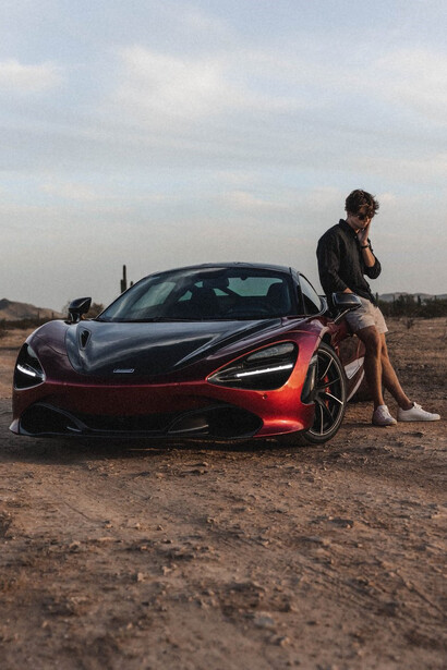 Sebastian Ghiorghiu proudly standing beside one of his lavish cars, Arizona, the USA