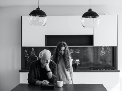 An elderly man and a woman expressing grief and sorrow