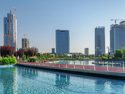 Contemporary buildings reflected in a pool at Tashkent City Park, Uzbekistan