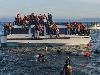 A boat carrying Syrian and Iraqi refugees arrives at Skala Sykamias, Lesvos, Greece