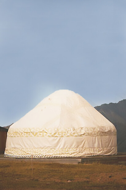 Mongolian yurts nestled beside majestic mountain