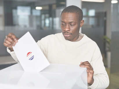 An African American man voting during the election process