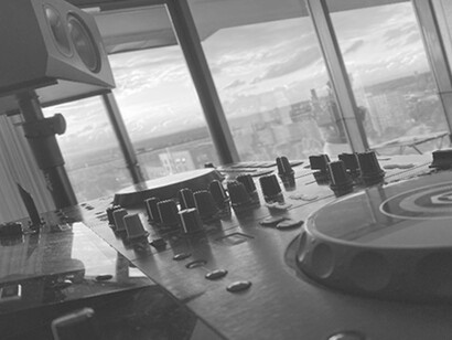 In this timeless black and white image, an audio mixer stands as an iconic symbol of musical creativity and technical prowess, evoking a sense of nostalgia for the classic era of music production
