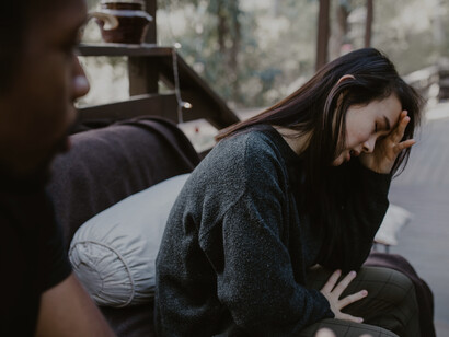 A woman looking distressed as her husband argues