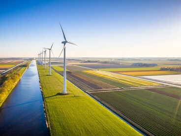Wind turbines generating electricity at a lakeshore wind farm