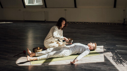 In a tranquil setting, the Reiki healer channels universal life force energy, aiming to restore harmony and balance in the recipient's energy field