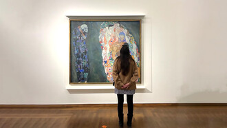 Catalina Rivera standing in front of Gustav Klimt, Life and Death, 1908-1915. Oil Paint on Canvas. Leopold Museum, Vienna