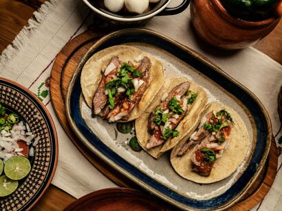 A rustic plate of freshly prepared tacos, symbolizing the unique flavors that make every destination memorable