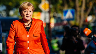 Angela Merkel in a vibrant red suit
