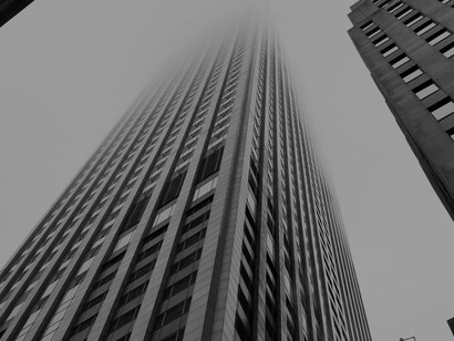 Skyscrapers rise above the financial district skyline, representing the power and scale of today’s global economy