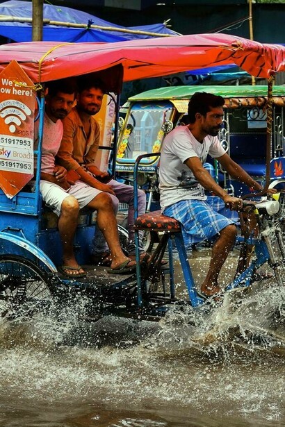Man takes passenger on a tricycle