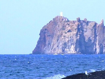 La isla farallón de Strombolicchio desde una playa de Stromboli