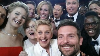 Celebrities posing for a selfie at the 2014 Oscar awards ceremony