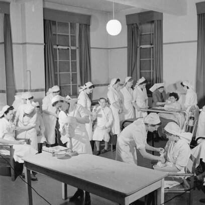 Vista de estudiantes de enfermería familiarizándose con el ambiente del hospital, adquiriendo las normas de etiqueta hospitalaria y practicando vendajes. 1943