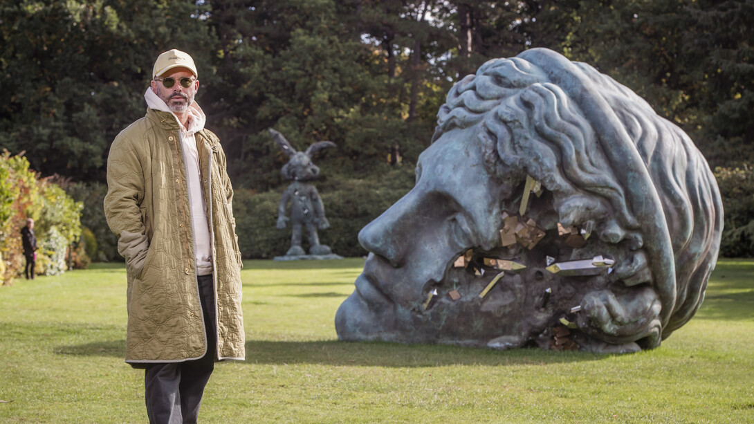 Daniel Arsham with Unearthed Bronze Eroded Melpomene, 2021. Installation view at Yorkshire Sculpture Park. Courtesy Perrotin Gallery and Arsham Studio. Photo by Anthony Devlin. Getty Images for Daniel Arsham