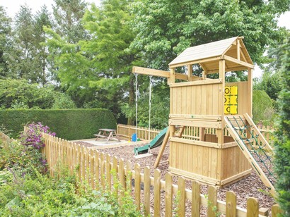 A playground set in the backyard area at Dominey’s Yard