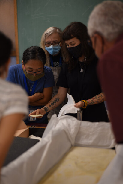 Left to right, Akiko Shinya,
Connie Van Beek, and
Jingmai O’Connor unpacking
the fossil in August 2022. Courtesy of Field Museum