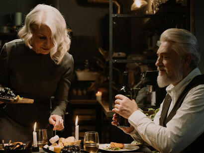 Over a table set with care and elegance, the act of savoring a gourmet meal becomes a cherished escape from the world's uncertainties