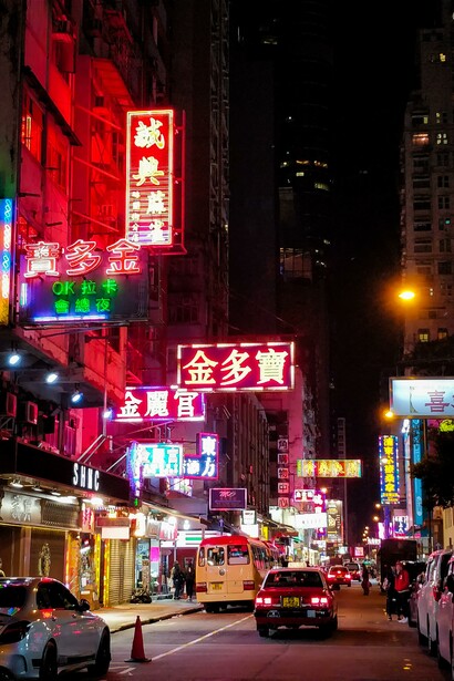 A street in a city at night. Advertising's influence extends beyond simply promoting products