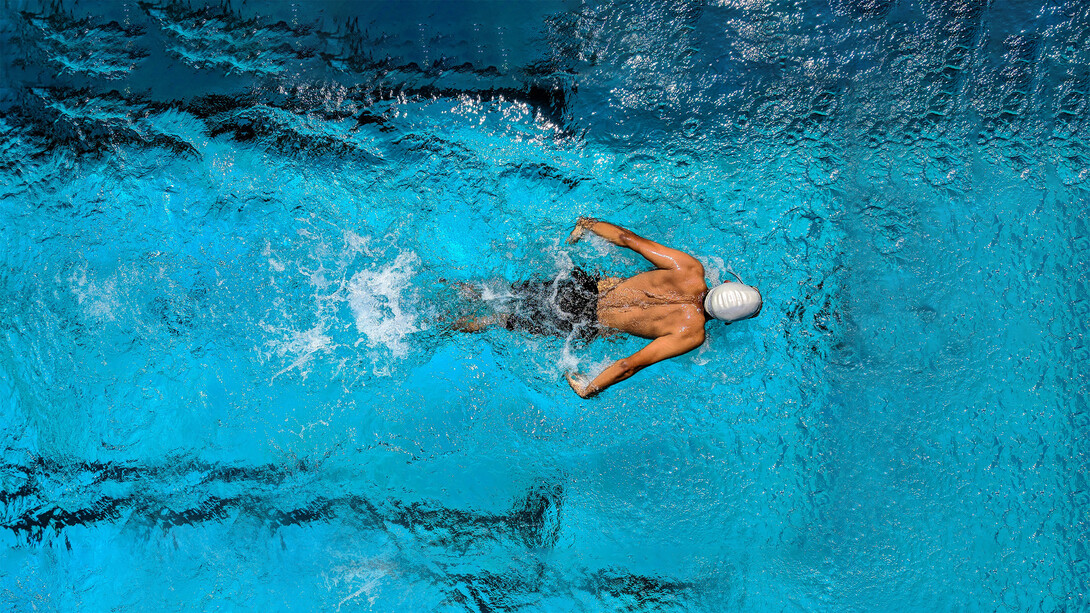 A swimmer gliding through open water, embodying focus and a winning mindset