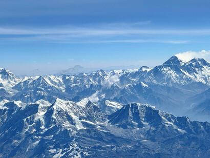 Breathtaking view of Everest from a plane, showcasing the Himalayan peaks