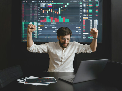 A man celebrating his successful investments