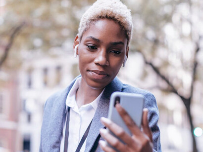 A woman effortlessly sends money to a friend's phone number, unlocking opportunities for financial mobility and independence