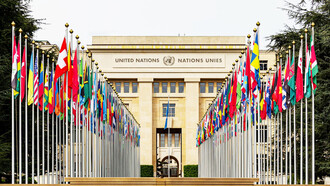 Against the backdrop of the Palais des Nations, the home of the United Nations Office in Geneva, Switzerland, the urgent need for global reform is evident as the world faces increasing conflicts and political turmoil