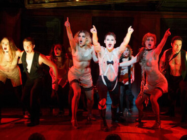 Cabaret's structure is very adaptable. The story is framed through performances at the Kit Kat Club, led by the Emcee