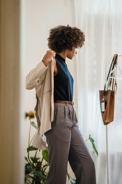 A woman getting dressed in her room before work