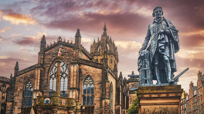 Statue of Adam Smith, widely considered to be the father of economics and capitalism, in front of St. Giles Cathedral on the Royal Mile in Old Town Edinburgh, Scotland 