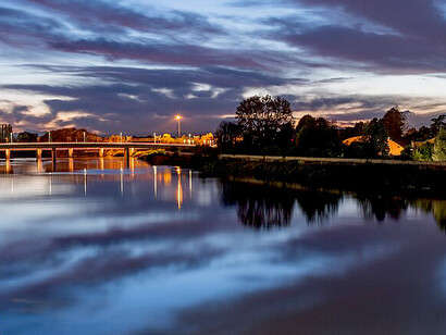 A nighttime view of the Tanaro River in Alessandria, Piedmont, Italy