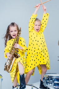 Joyful kids' music band delivers a lively performance in a recording studio, radiating happiness and musical enthusiasm