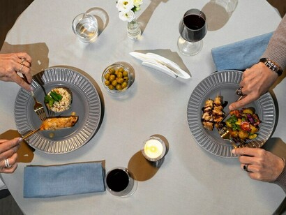 A top-down view of friends sharing a bottomless brunch at an upscale restaurant, complete with refreshing cocktails, prosecco, and an array of mouthwatering dishes spread across the table