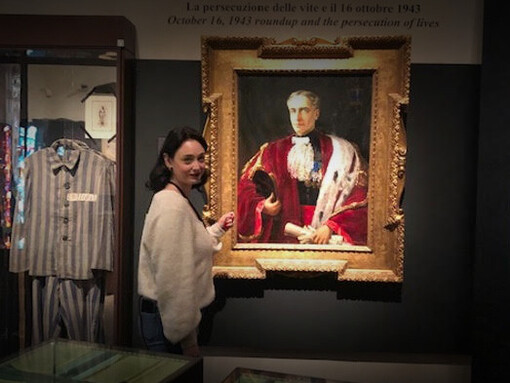 Museum educator Yael showing visitors the portrait of Ufgo Foà. He was the President of the Jewish Community of Rome, managing the emergency of the racial persecutions and deportations. Room 6 in the Jewish Museum of Rome

