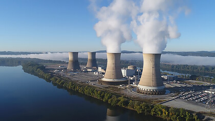The working cooling towers of Exelon Generation Unit 1 in the foreground are emitting water vapor. The dormant cooling towers are from Unit 2, which was permanently damaged in the 1979 accident, Pennsylvania, USA