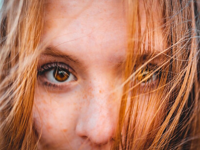 A woman with brown hair taking a selfie