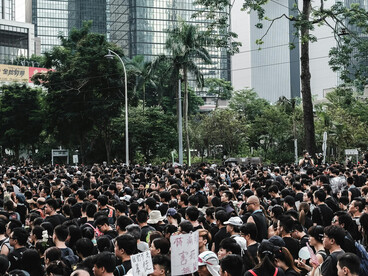 Thousands of demonstrators march through the streets of Hong Kong, voicing demands for democratic rights, political accountability, and social change