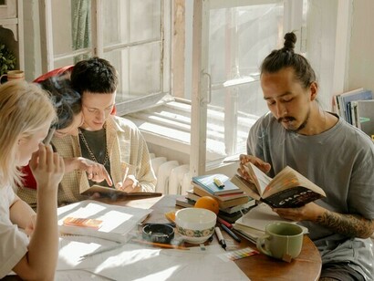 A group of friends reading books together