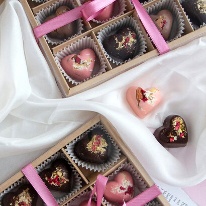 A close-up shot of elegant heart-shaped chocolates in a gift box, representing love, affection, and Valentine’s Day tradition