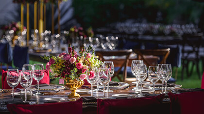Wine glasses and beautiful rose arrangement on display